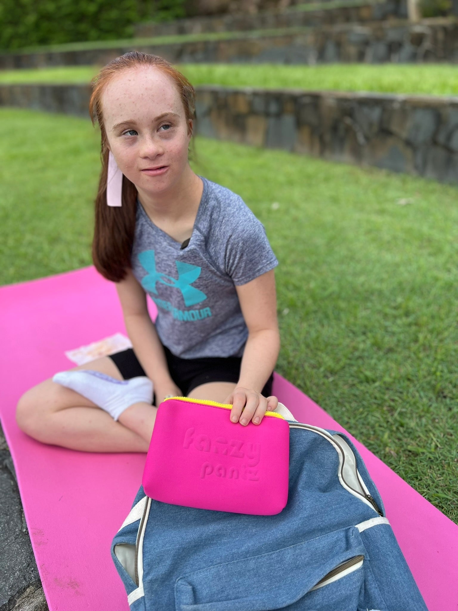 Tween girl holding her Fanzy Pantz period pouch