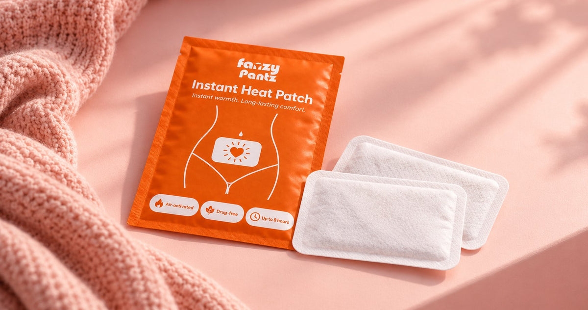 Fanzy Pantz Instant Heat Patch pack with two heat patches on a pink surface