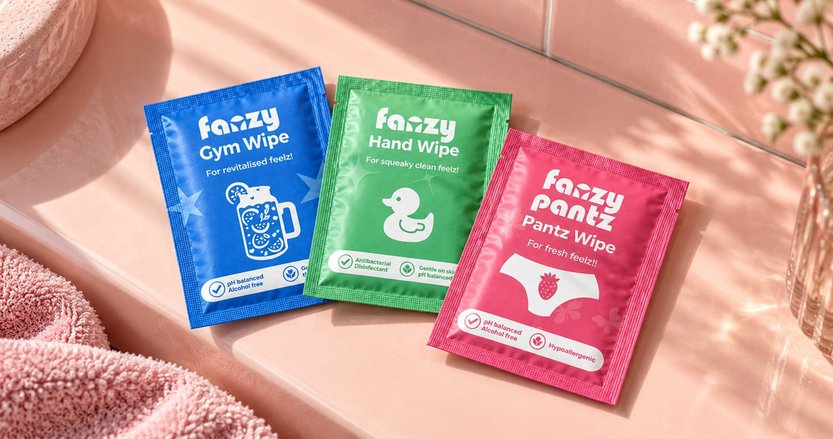 Fanzy Pantz gym, hand and pantz wipes in their packs on a pink surface