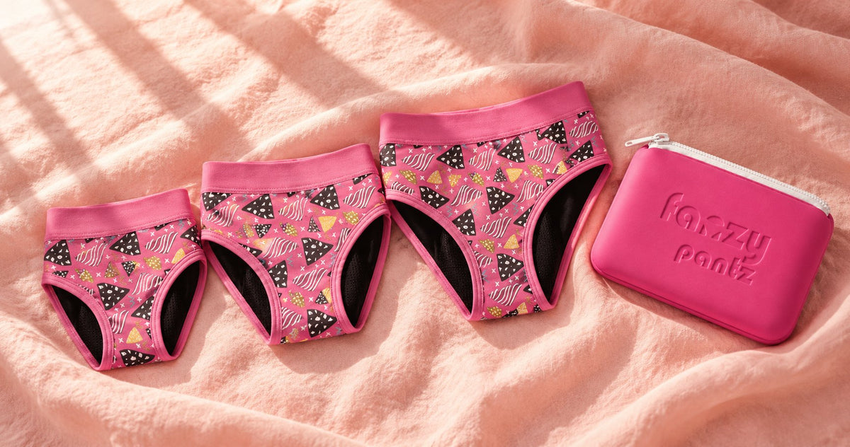 Three pairs of Fanzy Pantz tween period undies in different sizes beside a pouch